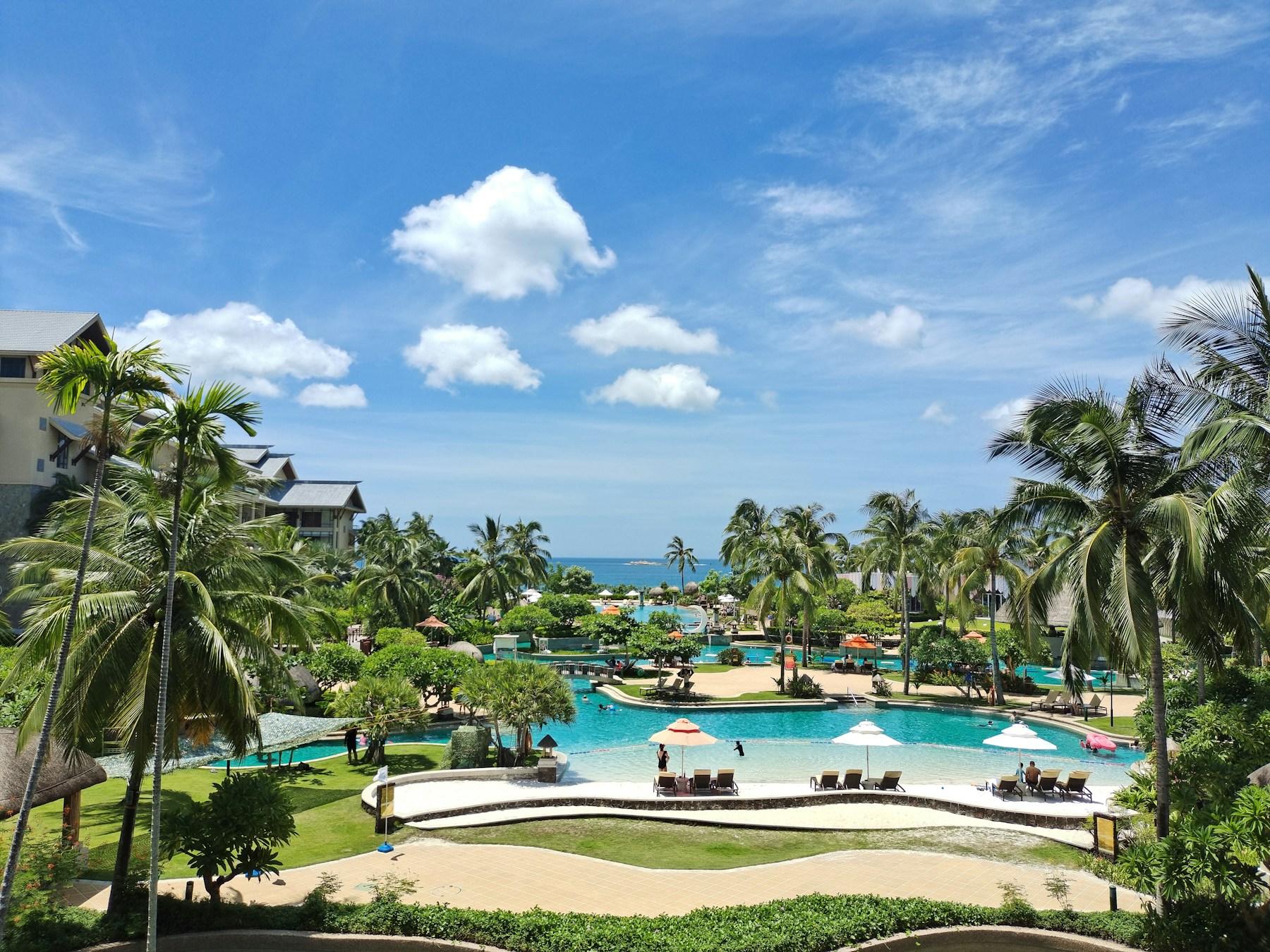 Palm trees and swimming pools at a resort in Yalong Bay, Sanya, China